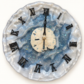 Handmade blue and pearl-white resin wall clock with black Roman numerals and a sand dollar center