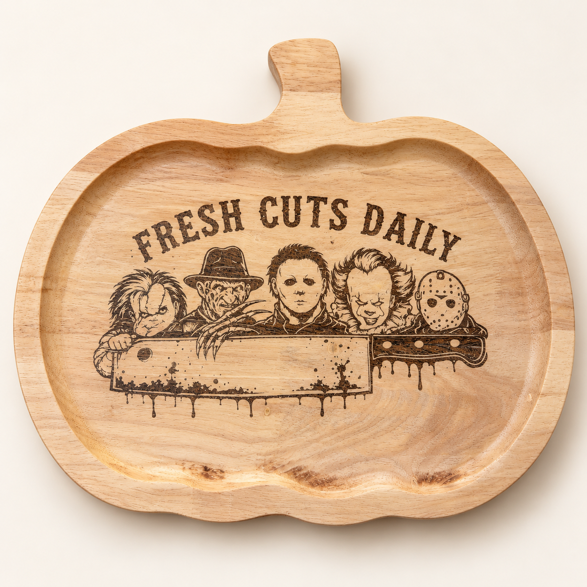 Pumpkin-shaped Fresh Cuts Daily horror engraved cutting board